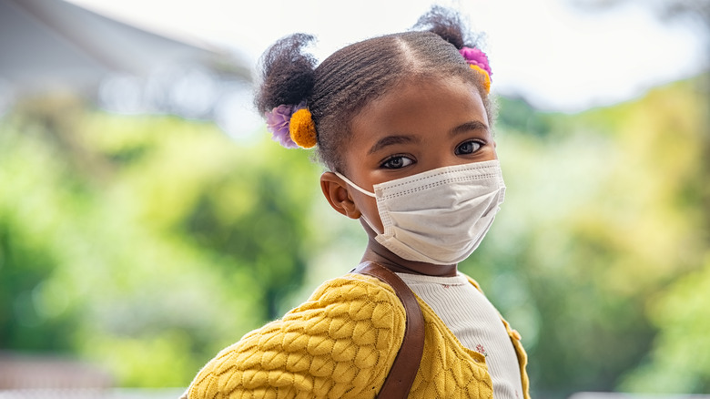 A child wearing a mask