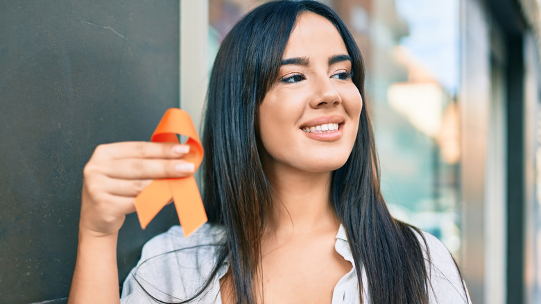 Woman holding MS awareness ribbon