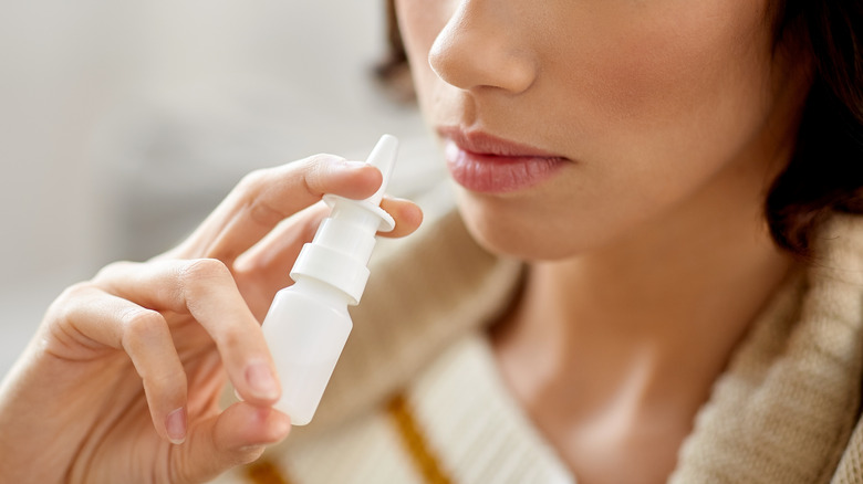woman using nasal spray