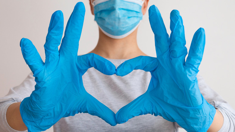 person making heart sign with hands