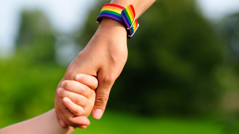 Parent holding kid's hand