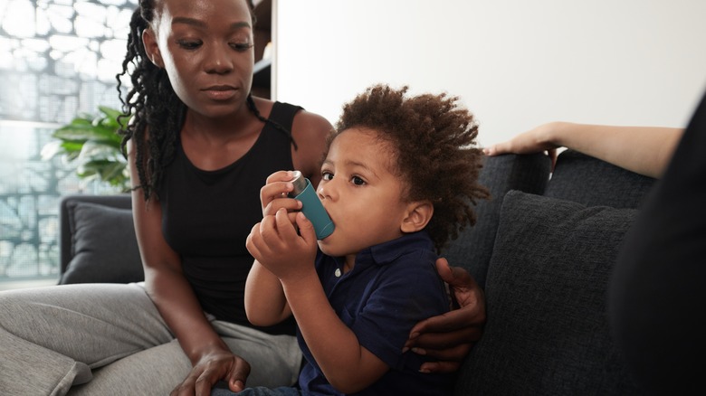 Child uses asthma inhaler
