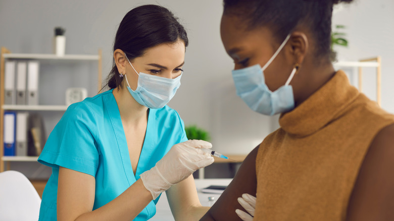 A woman gets a vaccine