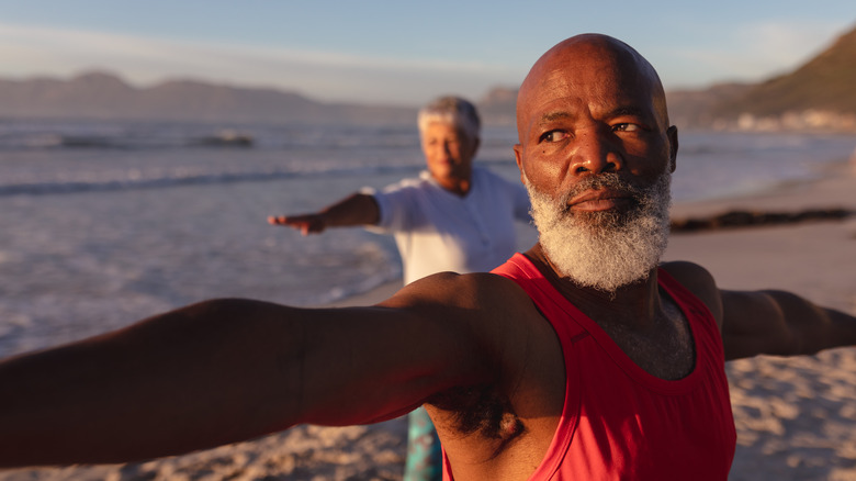 Mature couple doing yoga 