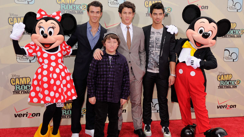The Jonas Brothers pose with Frankie Jonas, Minnie Mouse, and Micky Mouse for the premiere of "Camp Rock 2: The Final Jam"