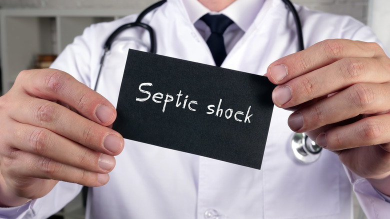 Doctor holding card saying septic shock