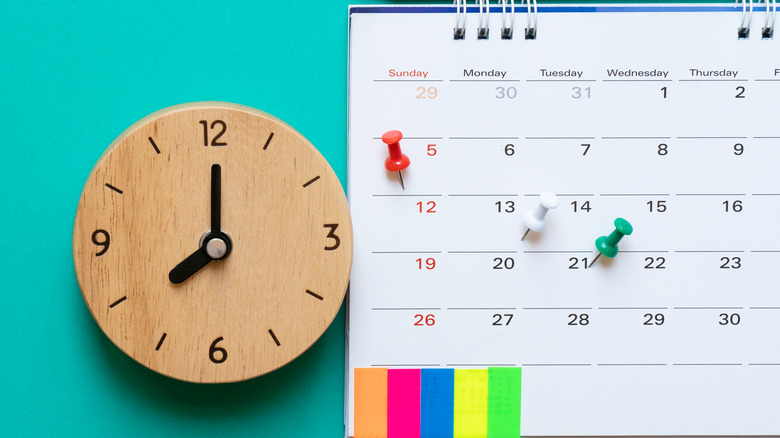 clock with calendar on blue background