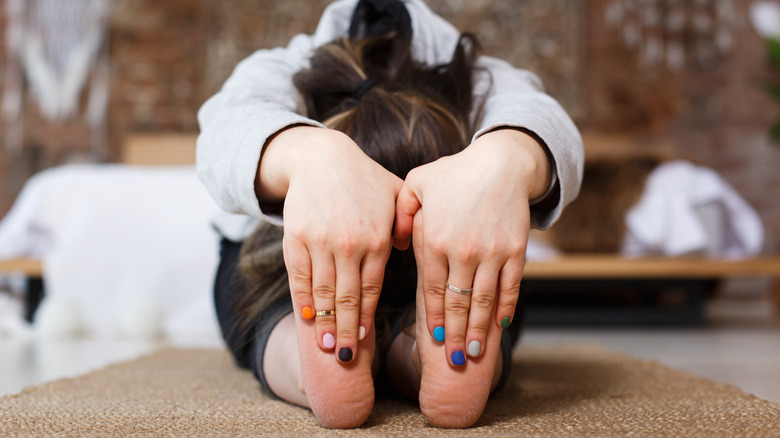 girl practices yoga on floor