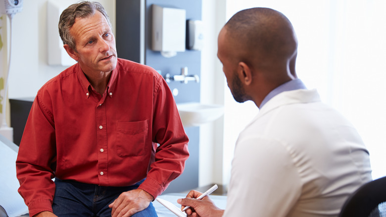 Middle-age man talking with his doctor