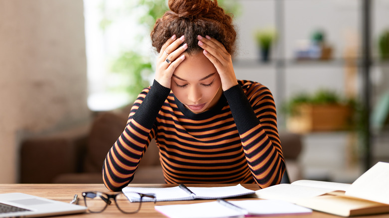 Woman experiencing stress while working