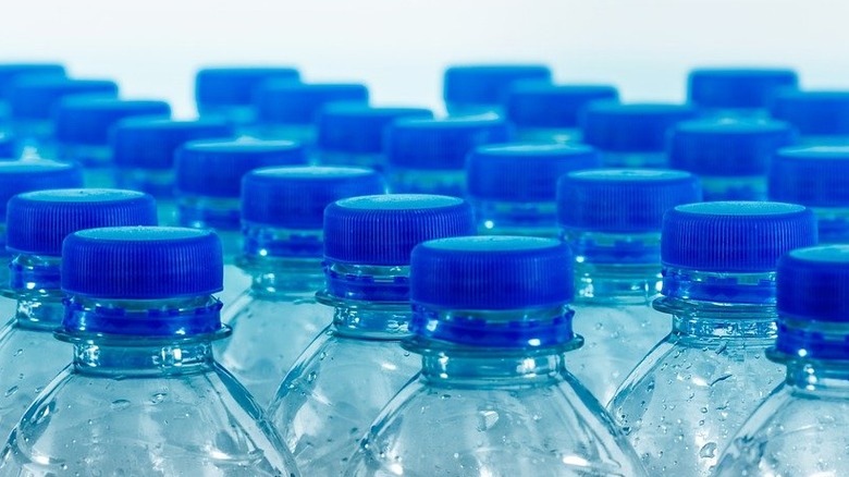 Clear water bottles with blue caps