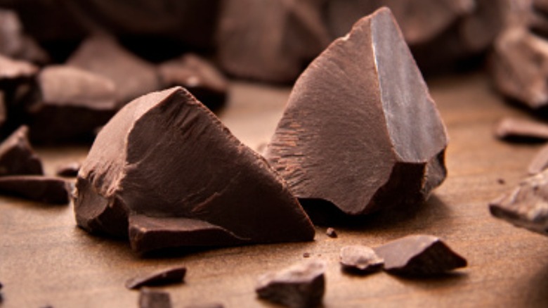 dark chocolate pieces on wood table