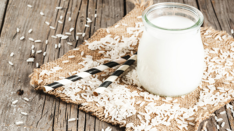 A close up of rice milk on a burlap cloth with rice grains around it