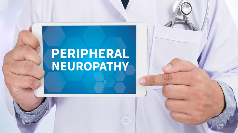 doctor holding up a tablet with peripheral neuropathy written on it