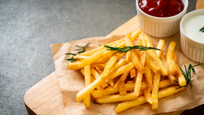 Pile of french fries with condiments