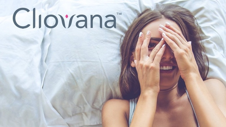 Woman in bed smiling with the Cliovana logo overlaid on the image