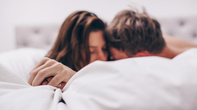 Couple kissing in bed