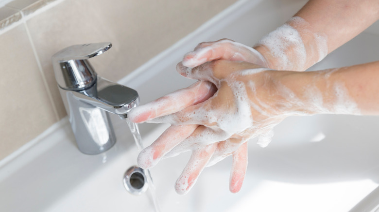 woman obsessively washing hands
