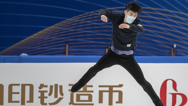 Chinese skater practices with mask on