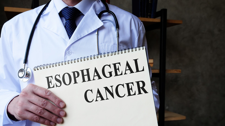 doctor holding up clipboard with the words "ESOPHAGEAL CANCER"