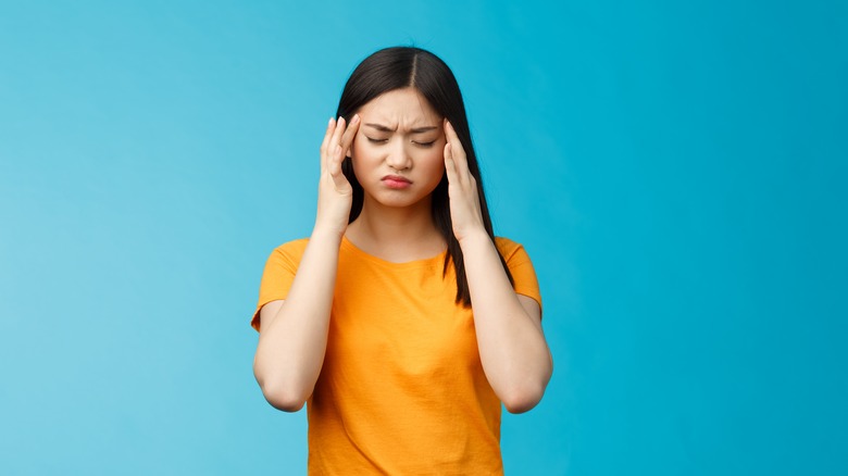 young woman suffering from headache 