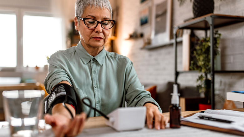 woman taking blood pressure reading