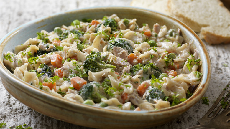 A tuna noodle casserole with peas, carrots, and broccoli