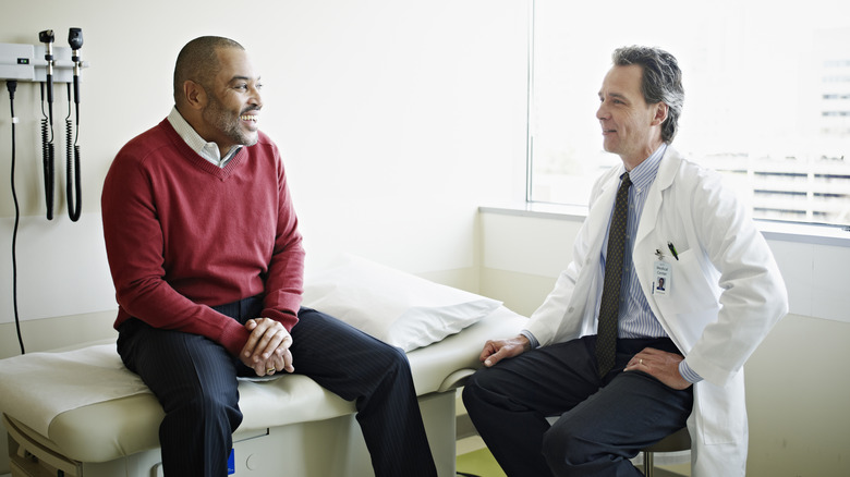 A man talking to his doctor in an examination room