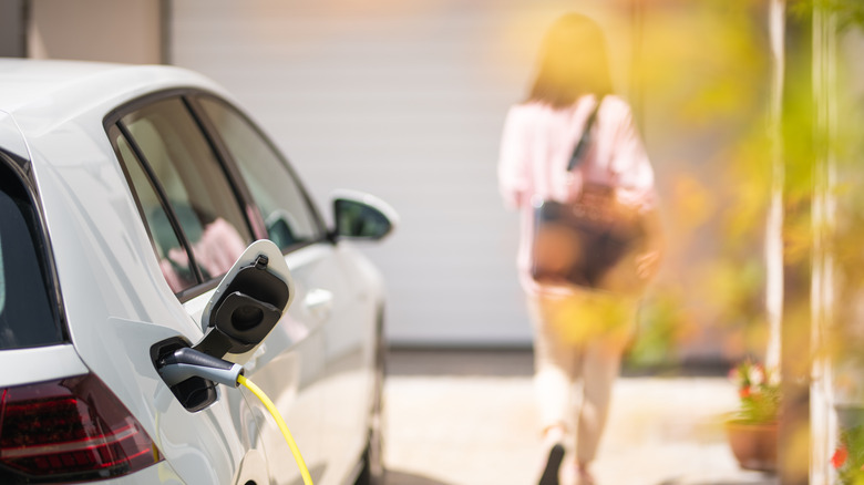 A woman walking away from her car