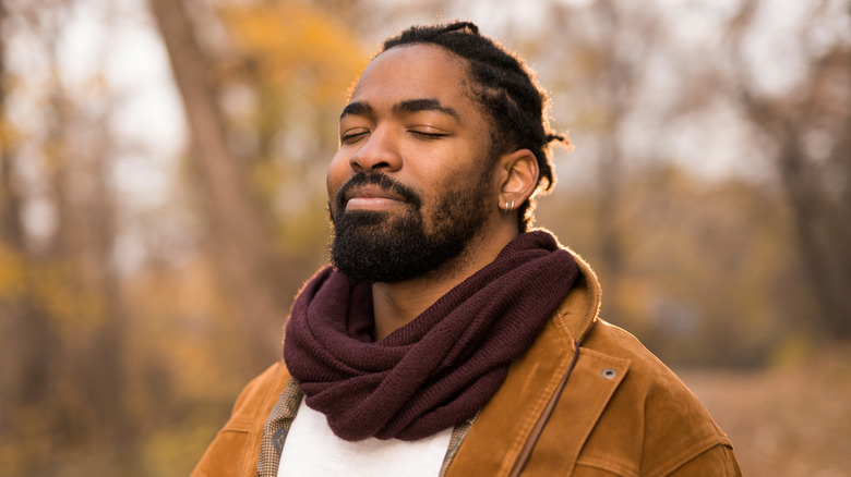 man smiling while on nature walk