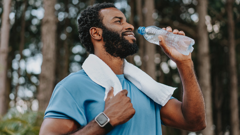 Man exercising and drinking water bottle