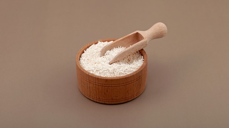 A wooden bowl filled with potassium sorbate