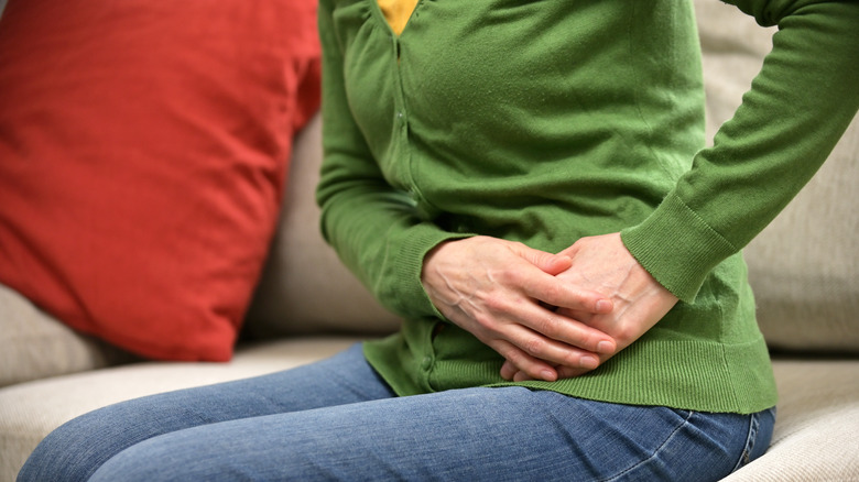 Woman holding abdomen