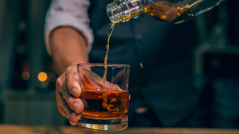 brown alcohol being poured neat