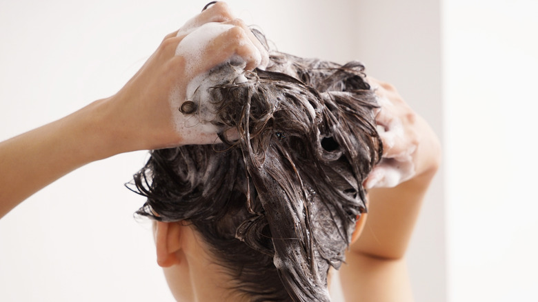 a person washing their hair in the shower