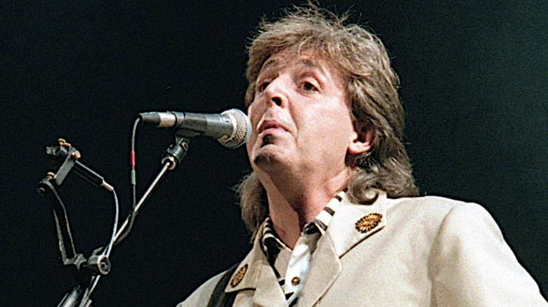 Paul McCartney singing into microphone 