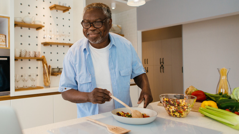 Older man cooking healthy meal