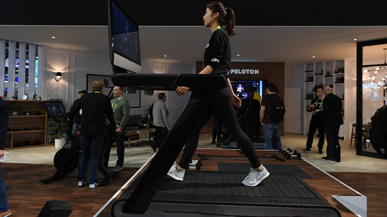 woman walking on peloton treadmill