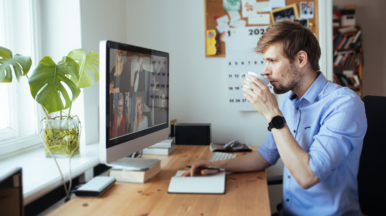 Man enjoying coffee while working on the computer