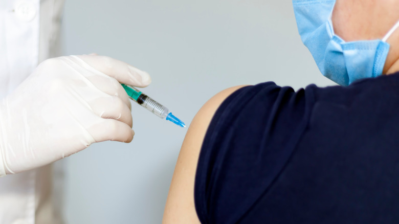 Masked patient receiving vaccine