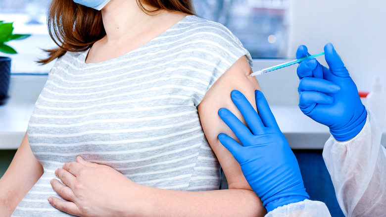 pregnant woman getting her covid vaccine