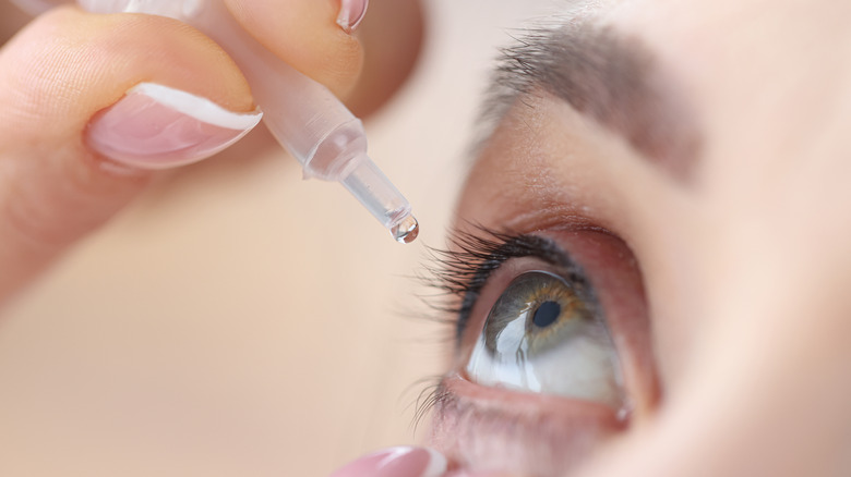 Person using eye drops