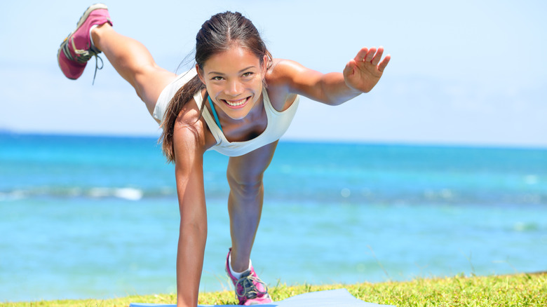 woman doing superman plank