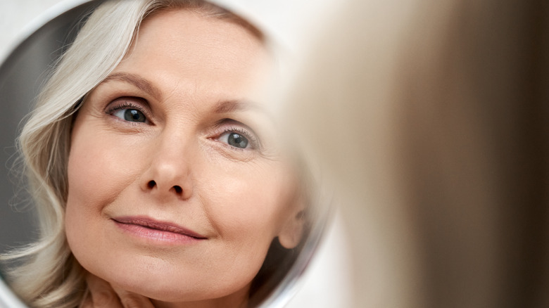 woman looking happy in mirror