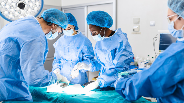 A surgical team performs surgery