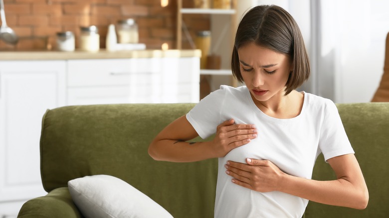 Woman examining their breast