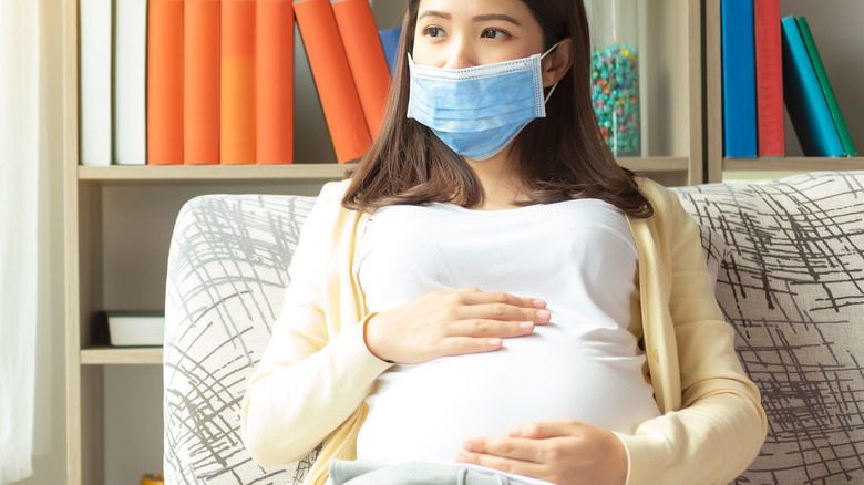 Pregnant woman wearing mask