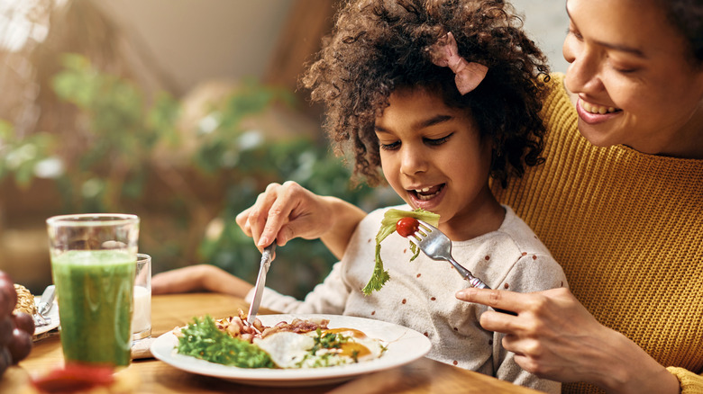 mom and daughter share healthy meal