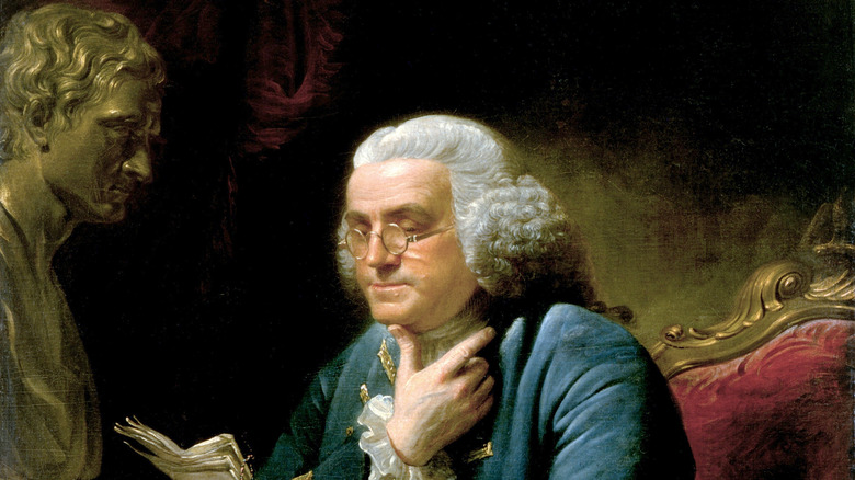 Founding Father Benjamin Franklin reading the newspaper