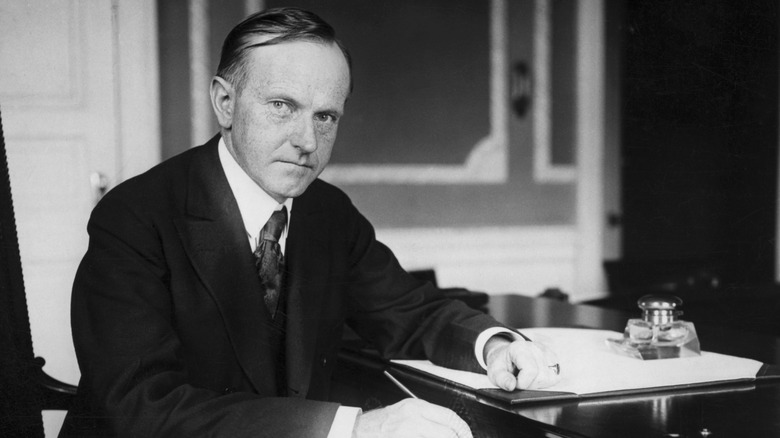 President Calvin Coolidge sitting at his desk